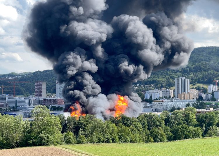 A fire burns at an industrial building outside Zurich, Switzerland May 29, 2022. Fabio Storni/Handout via REUTERS